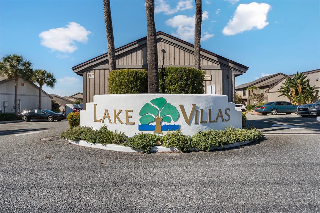 A white monument sign for Lake Villas sits in front of a multi-unit residential building — 670 LAKE VILLAS DRIVE UNIT C, ALTAMONTE SPRINGS, FL