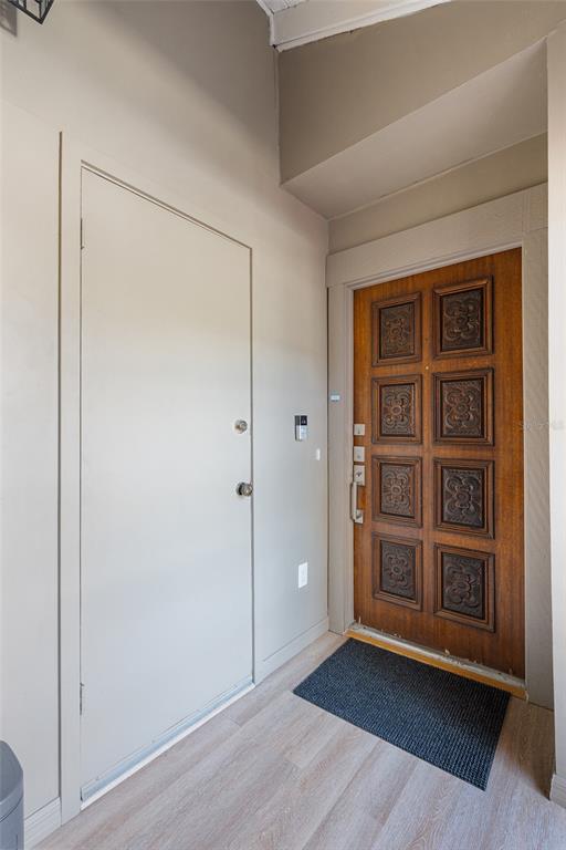 An entryway features a light-colored door, a decorative wooden door, and light wood-look flooring — 670 LAKE VILLAS DRIVE UNIT C, ALTAMONTE SPRINGS, FL