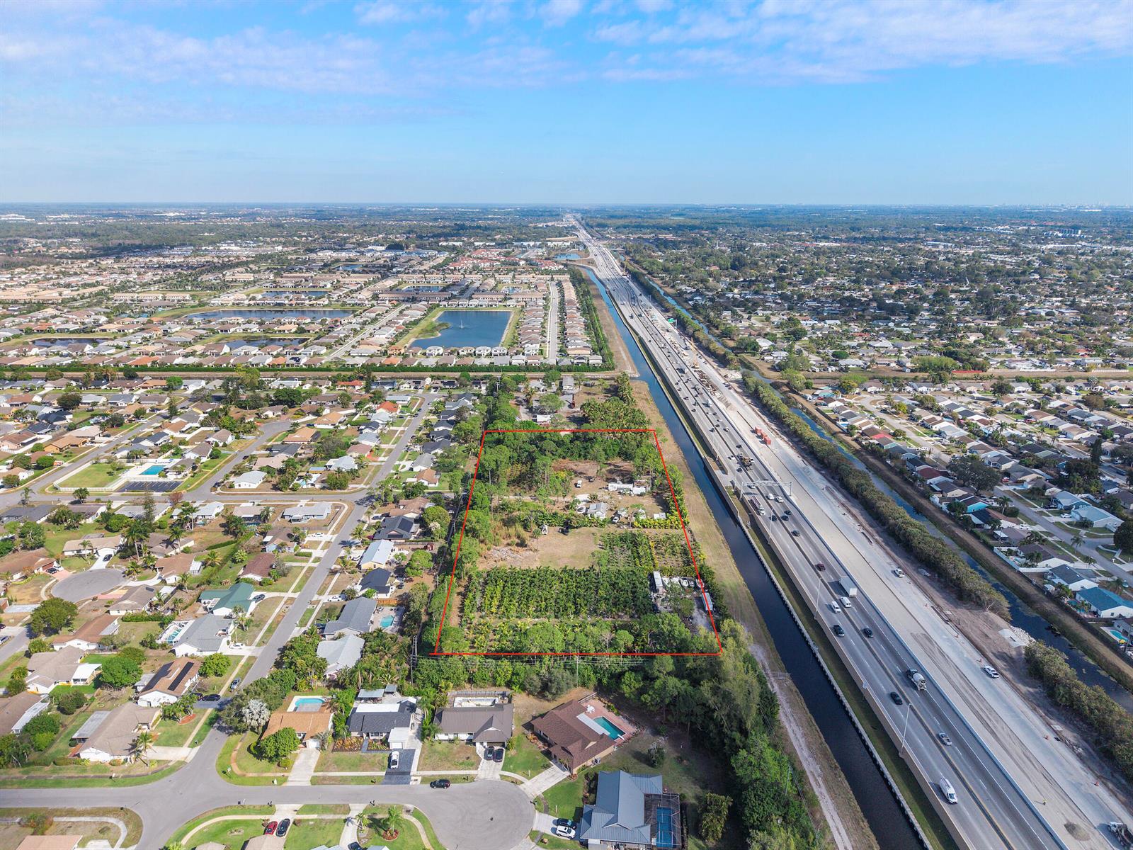An aerial view shows a rectangular plot of land outlined in red next to a highway — 5387 80th Trail S, Lake Worth FL 33467, LAKE WORTH, FL