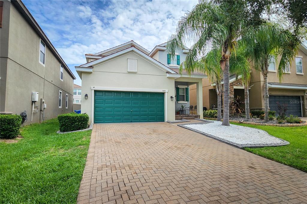 A single-story house with a green garage door and a paved driveway — 949 TERRA VISTA STREET, BRANDON, FL