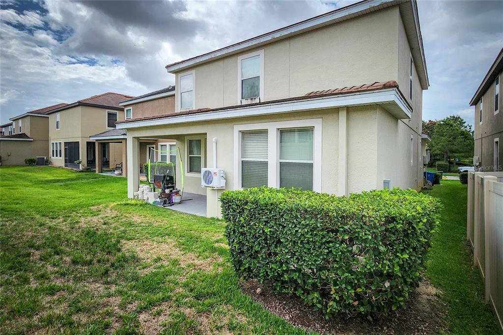 The exterior of a two-story house features a covered patio and a large hedge — 949 TERRA VISTA STREET, BRANDON, FL