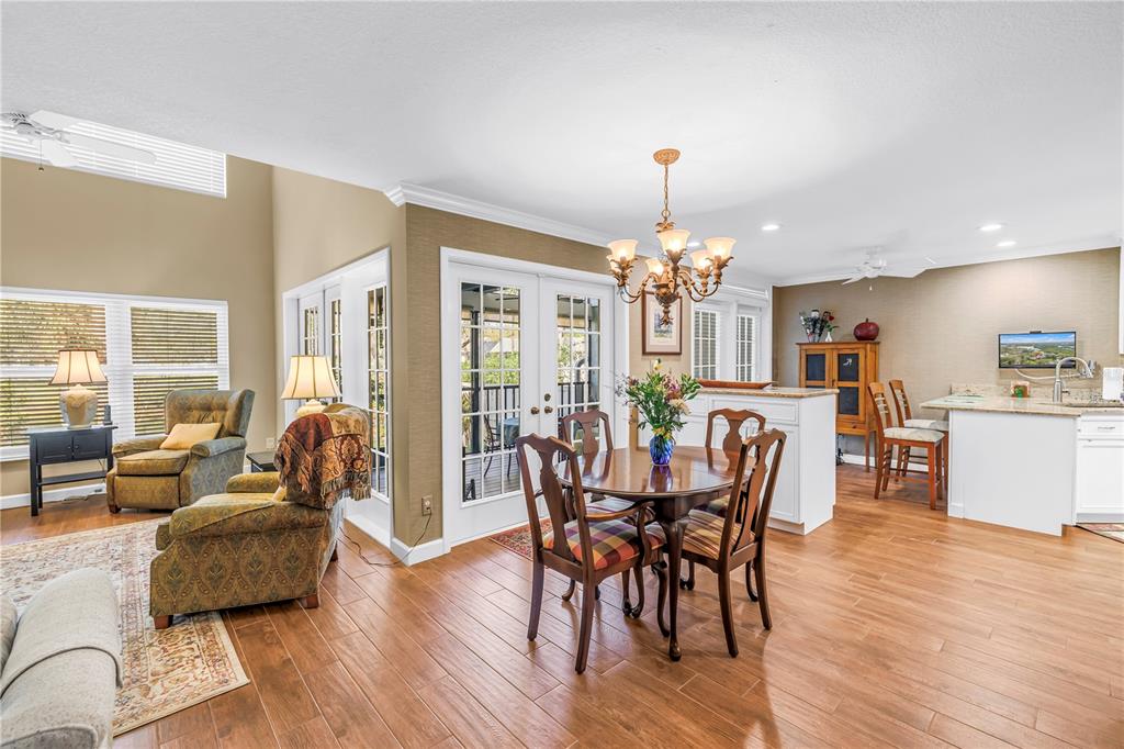 A two-story house with light blue siding, a garage, and a white gate entrance — 812 AMELIA COURT NE, ST PETERSBURG, FL