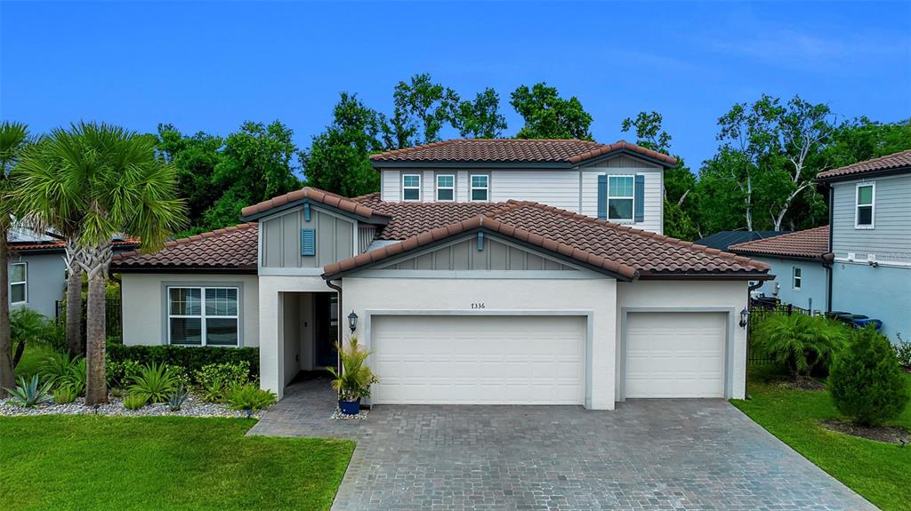 A two-story house with a tiled roof, a two-car garage, and a paved driveway — 7336 GREAT EGRET BOULEVARD, SARASOTA, FL
