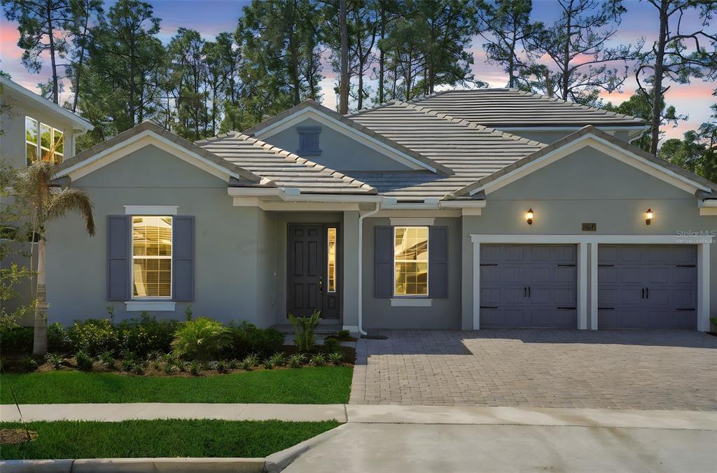 A single-story house with a gray exterior, tiled roof, and a two-car garage — 14371 CREST PALM AVENUE, WINDERMERE, FL