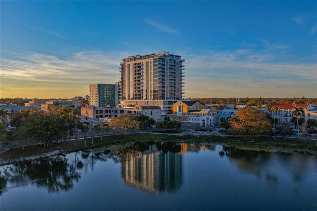 A rooftop terrace features a circular fire pit surrounded by white outdoor seating — 777 3RD AVENUE N UNIT 1202, ST PETERSBURG, FL
