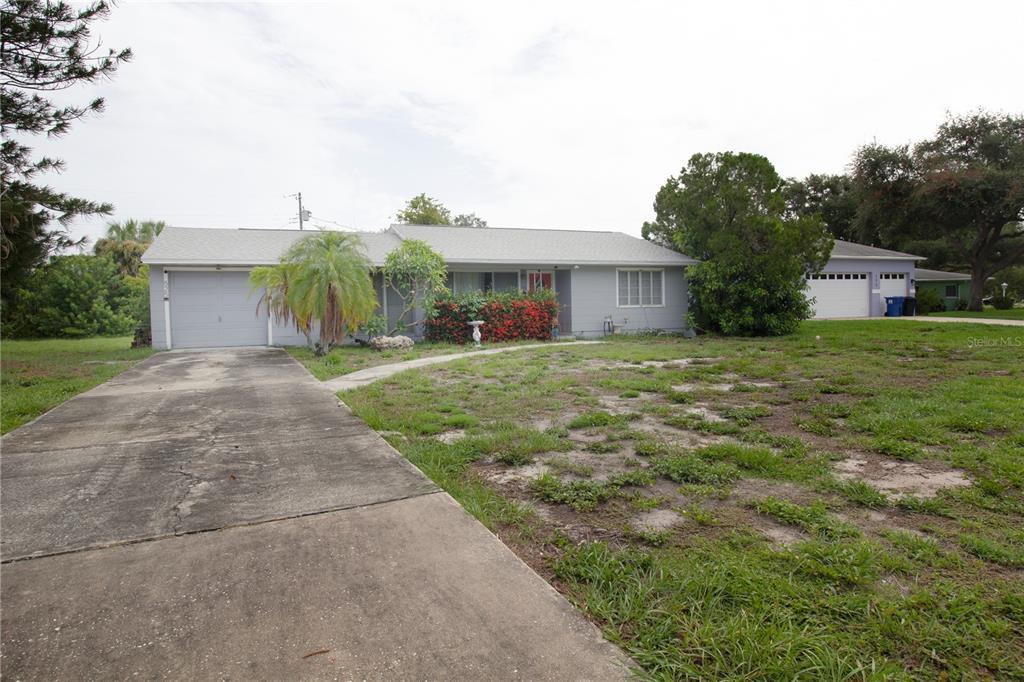 A single-story gray house with a concrete driveway and a detached garage — 525 HAMPTON AVENUE NE, ST PETERSBURG, FL