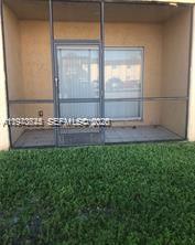 A screened-in patio with a sliding glass door overlooks a patch of green grass — 2834 NW 55th Ave # 1C, Lauderhill FL 33313, LAUDERHILL, FL