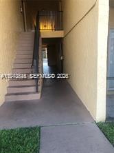 An exterior view shows a concrete staircase leading to an upper-level walkway — 2834 NW 55th Ave # 1C, Lauderhill FL 33313, LAUDERHILL, FL