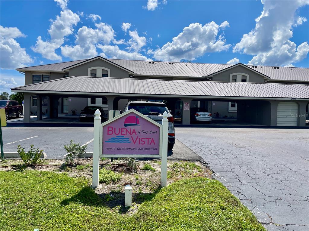 A sign for Buena Vista of Deep Creek stands in front of a multi-unit building — 1335 SAXONY CIRCLE UNIT 322, PUNTA GORDA, FL