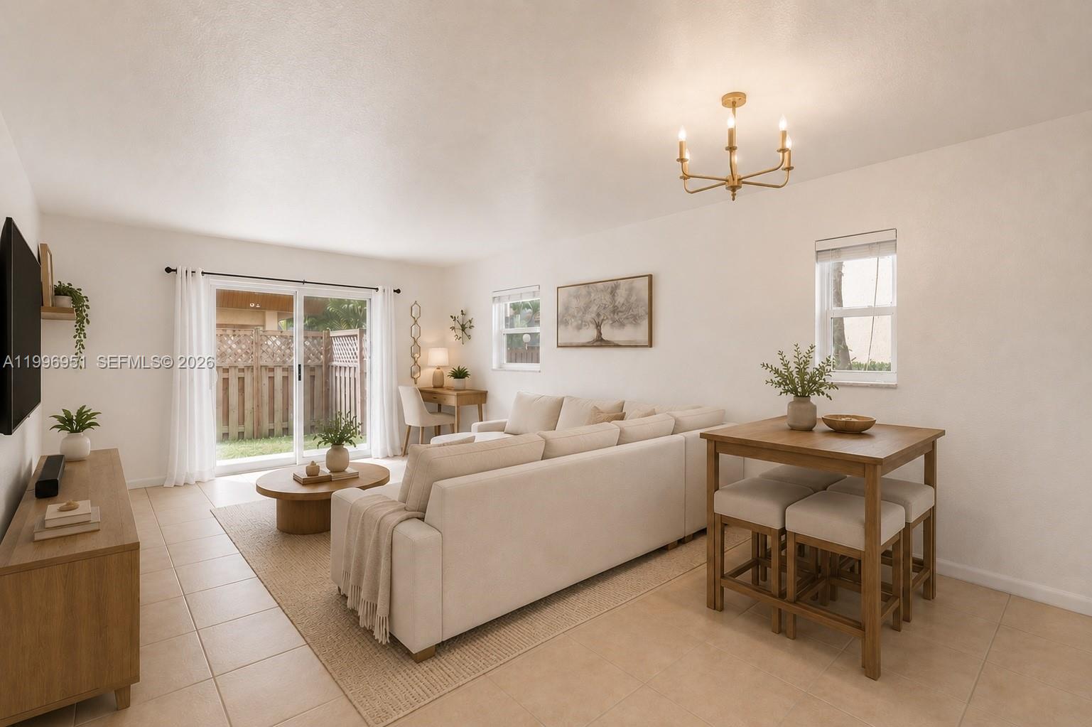 A living room features a beige sectional sofa, a dining table, and a sliding glass door — 8500 SW 109th Ave # 114, Miami FL 33173, MIAMI, FL