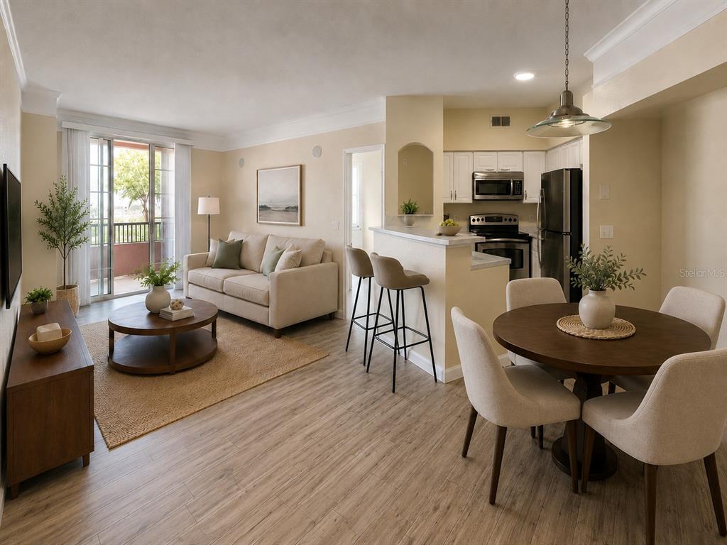 A kitchen with white cabinets and stainless steel appliances opens to a dining area — 3280 SOHO STREET UNIT 201, ORLANDO, FL