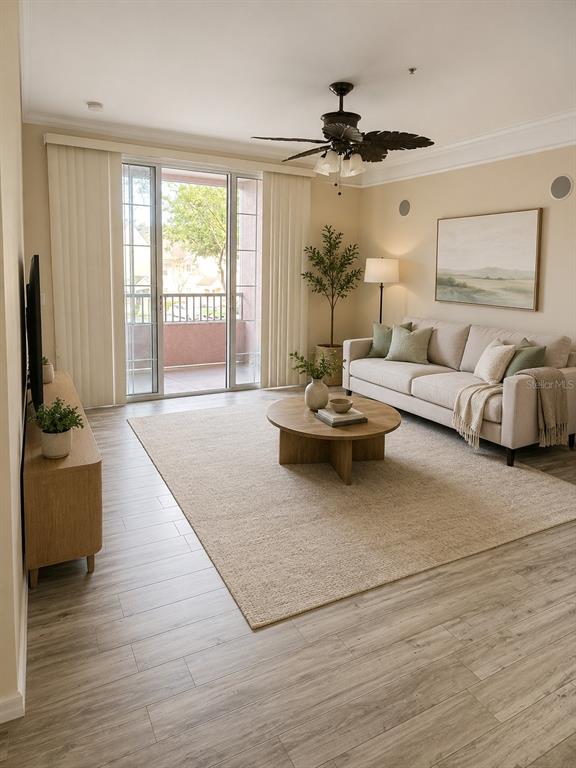 A kitchen with white cabinets and stainless steel appliances sits beside a small dining area — 3280 SOHO STREET UNIT 201, ORLANDO, FL