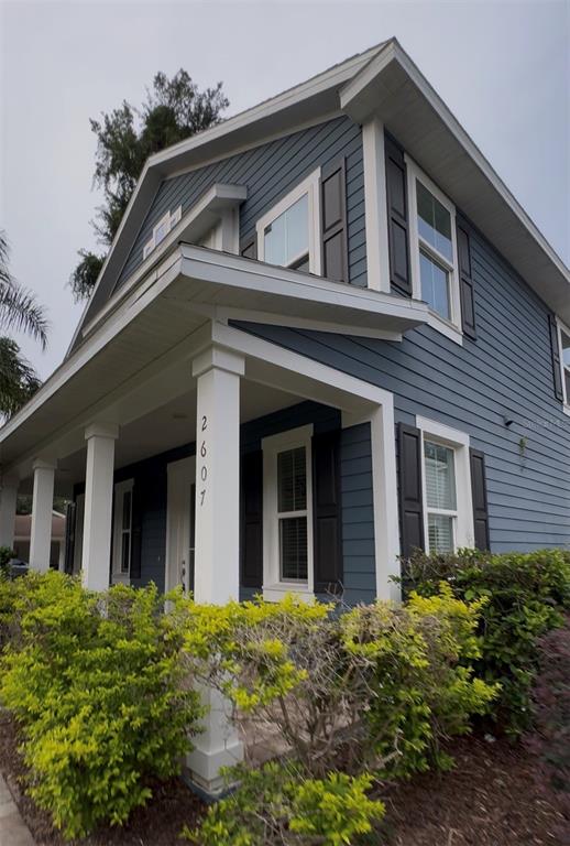 A two-story house with blue siding, a covered front porch, and white trim — 2607 S BROWN AVENUE, ORLANDO, FL
