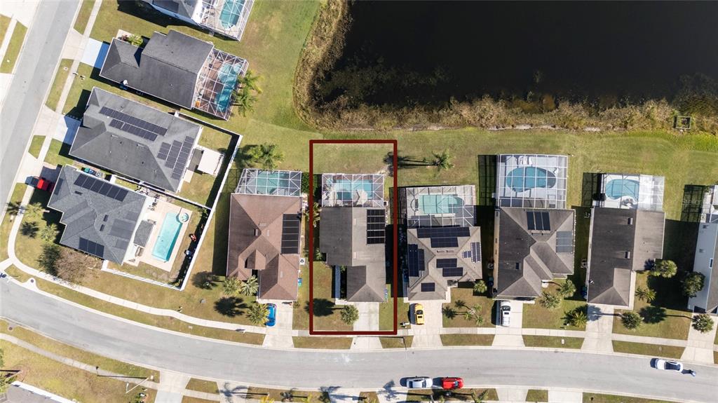 An aerial view shows a residential house with a pool and solar panels — 1611 BRIDGEVIEW CIRCLE, ORLANDO, FL