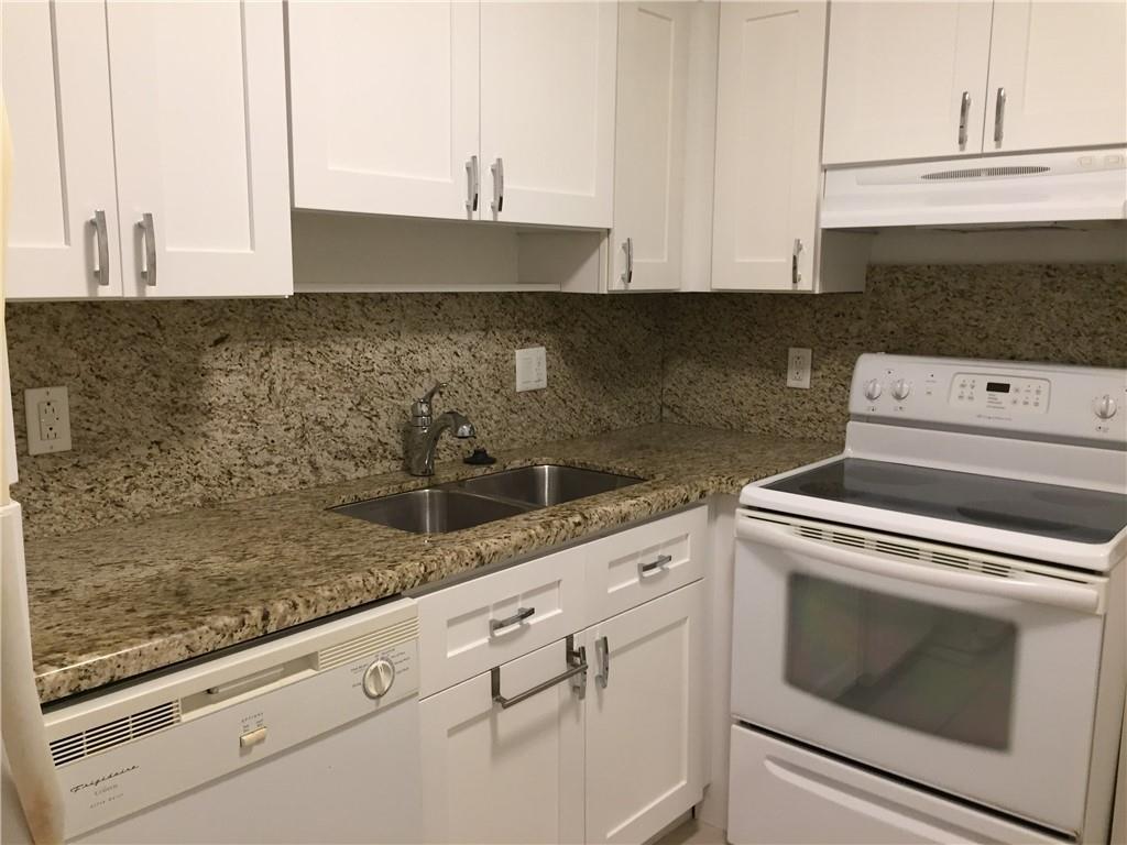 A kitchen with white cabinets, granite countertops, and white appliances — 4040 N Hills Drive # 7, Hollywood FL 33021, HOLLYWOOD, FL
