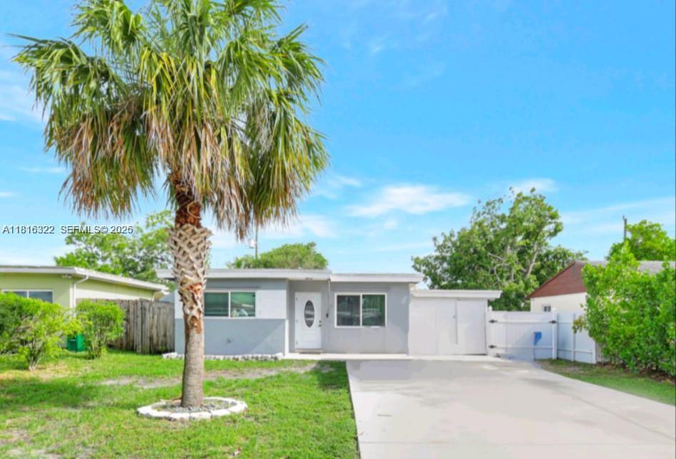 A single-story house with a gray exterior, a palm tree in the front yard, and driveway — 6336 SW 22nd St, Miramar FL 33023, MIRAMAR, FL