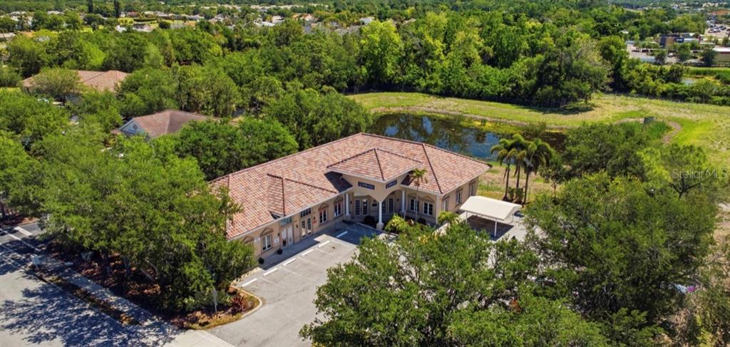 An aerial view of a single-story commercial building with a tile roof and parking lot — 5275 OFFICE PARK BOULEVARD, BRADENTON, FL
