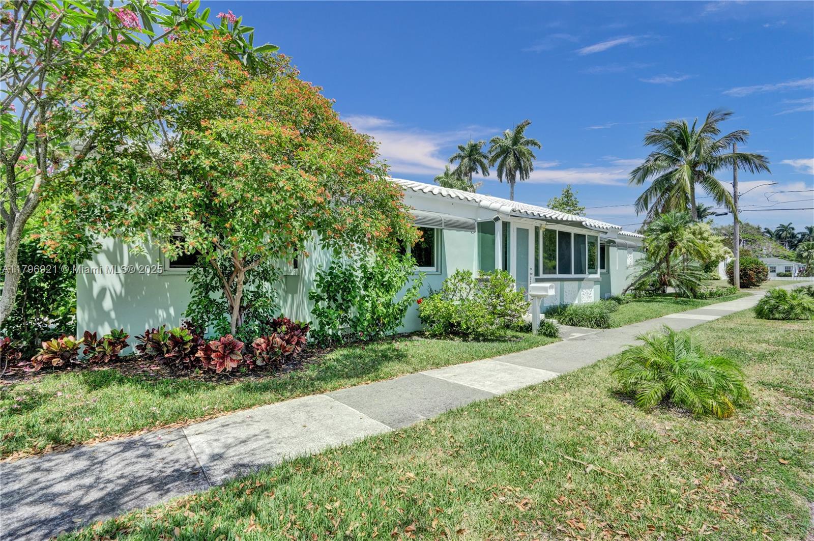 A light green single-story house with a white tile roof and a front sidewalk — 326 S 14th Ave, Hollywood FL 33020, HOLLYWOOD, FL