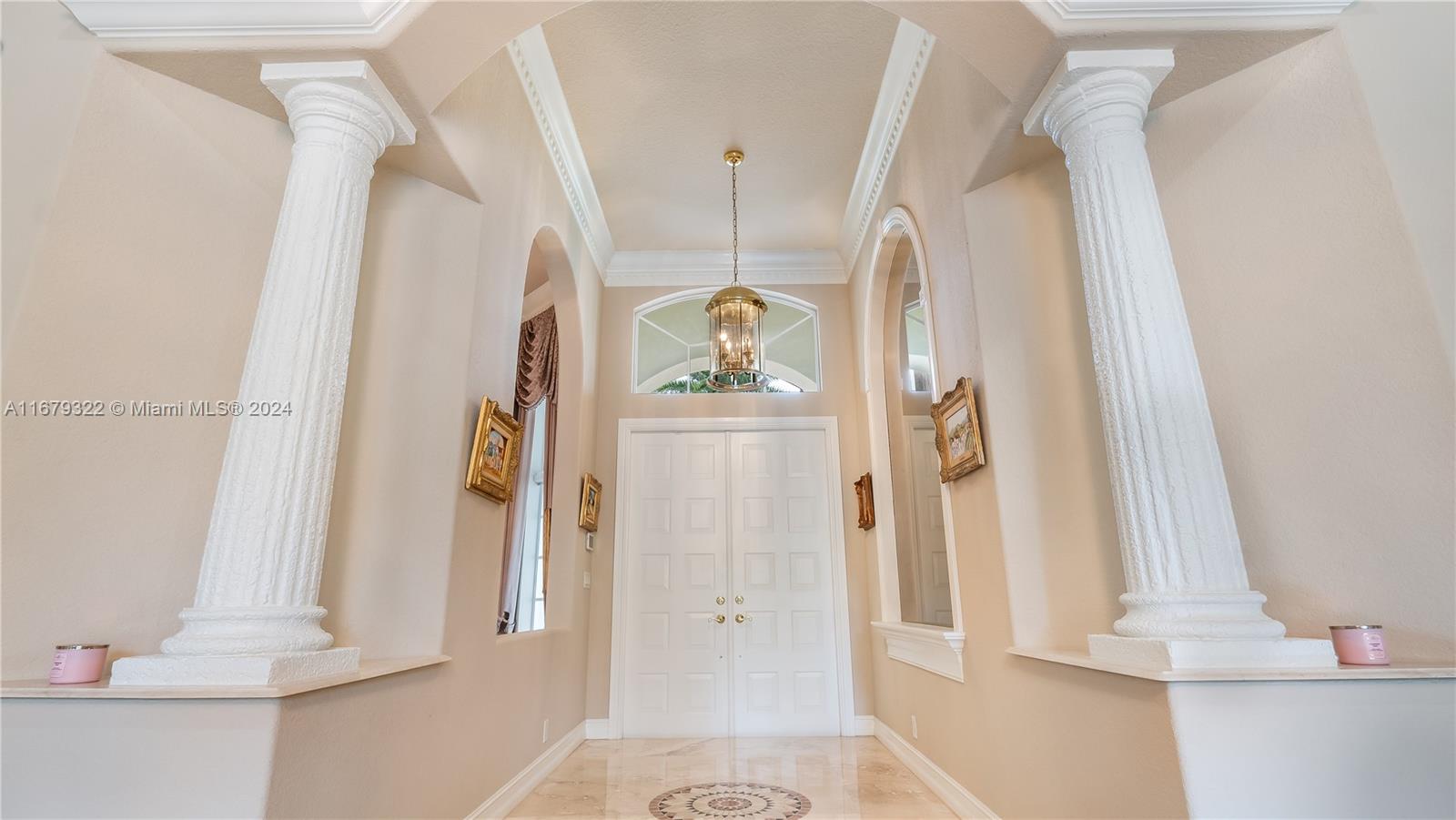 A grand foyer features two white columns, a high arched ceiling, and double entry doors — 12854 Stonebrook Dr, Davie FL 33330, DAVIE, FL