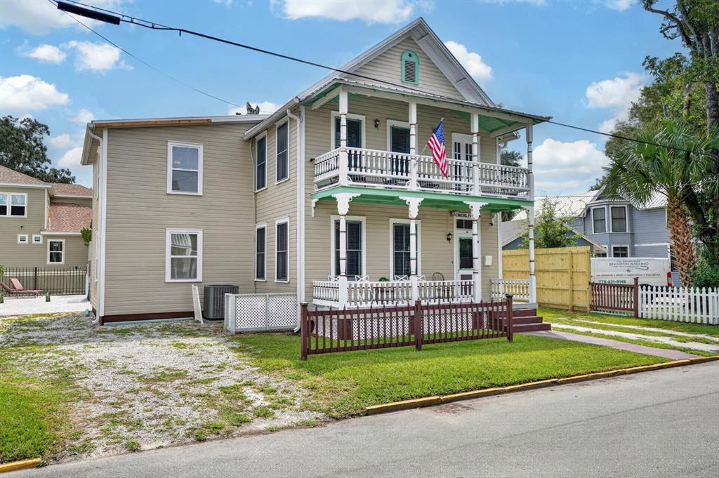 A two-story house with light siding, a front porch, and a second-story balcony — 31 SANFORD STREET, ST AUGUSTINE, FL