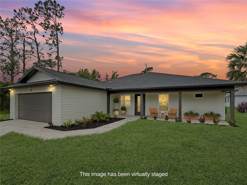 A single-story house with a garage, covered porch, and lawn under a sunset sky — 73 BARSTOW STREET, PORT CHARLOTTE, FL
