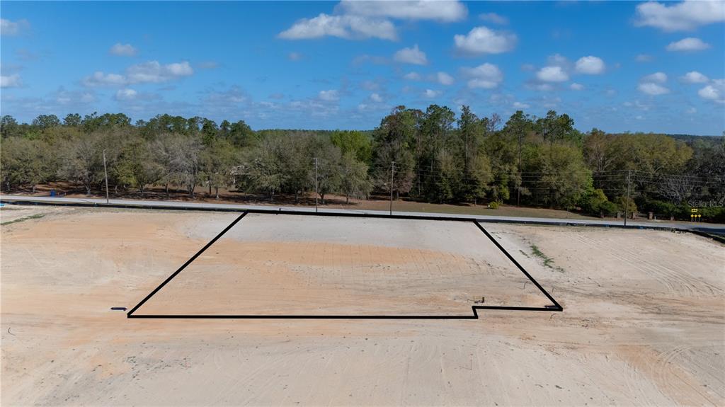 An aerial view shows a cleared, rectangular plot of land outlined in black — 12927 POMPANIC STREET, SAN ANTONIO, FL