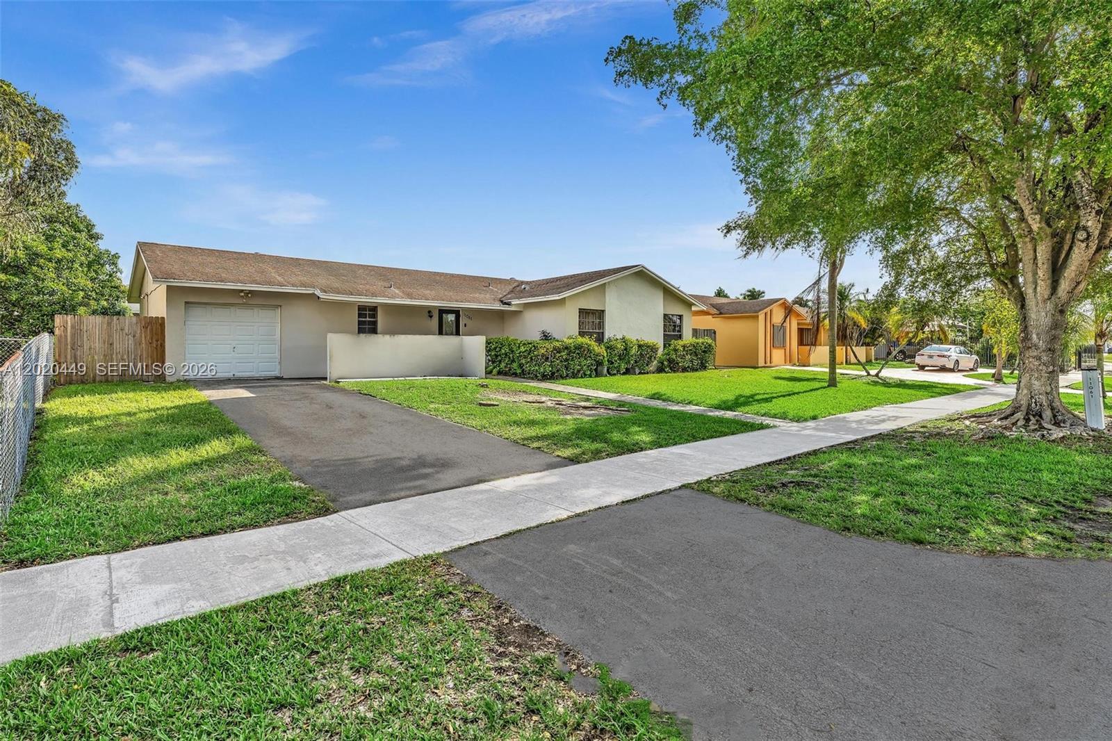 A single-story house with a beige exterior, a one-car garage, and a front lawn — 11061 SW 163rd St, Miami FL 33157, MIAMI, FL