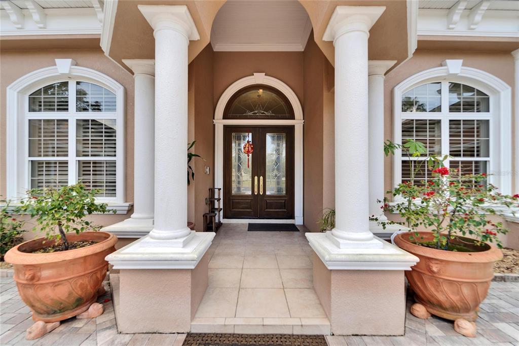 A front entryway features a double door with a transom window flanked by two columns — 8510 KENTUCKY DERBY DRIVE, ODESSA, FL