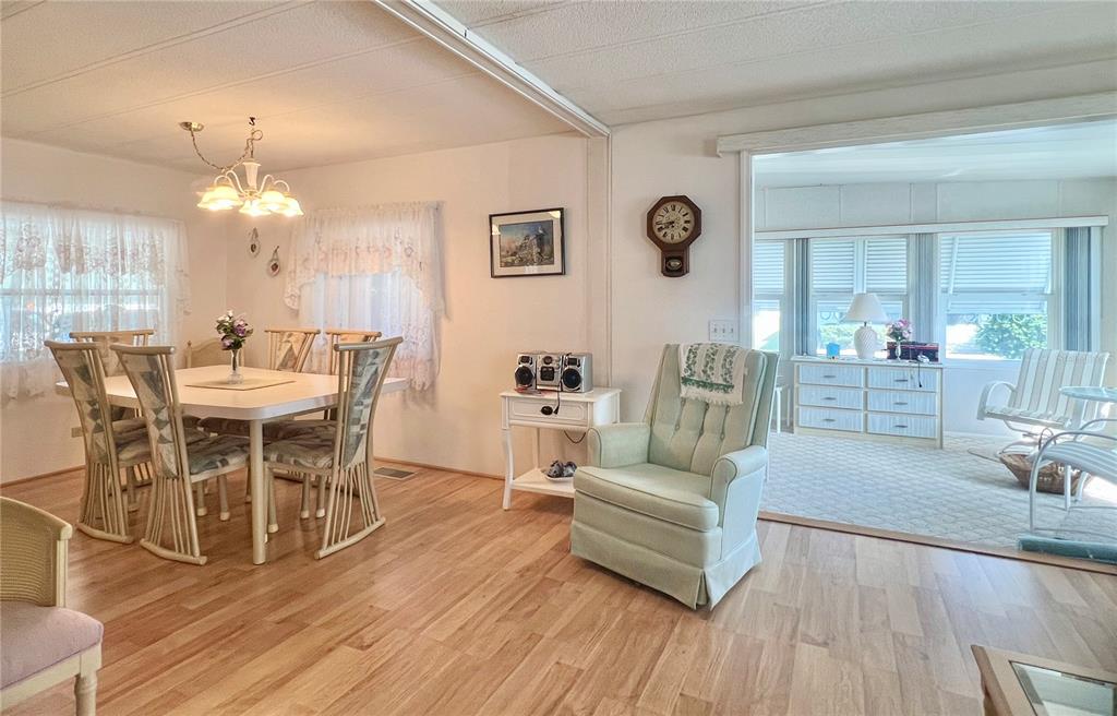 A white mobile home with a carport and a parked SUV under a blue sky — 1100 BELCHER ROAD S UNIT 197, LARGO, FL