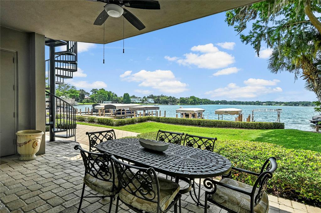 A grassy lawn overlooks a lake with several boat docks under a blue sky — 660 OSCEOLA AVENUE UNIT 101, WINTER PARK, FL