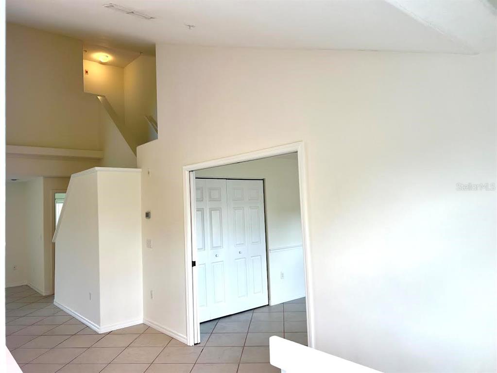 A room with tiled floors, a white wall, and a doorway leading to a closet — 8370 WINGATE DRIVE UNIT 726, SARASOTA, FL