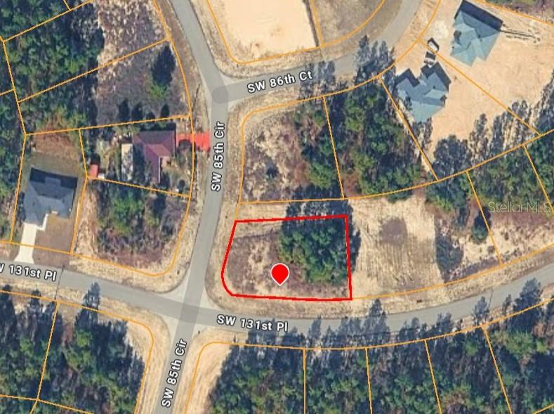 This is an aerial map view of a vacant, wooded residential lot outlined in red — SW 131ST PLACE, OCALA, FL