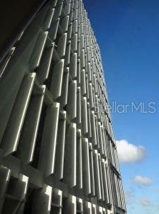 A low-angle view of a tall building exterior featuring vertical concrete louvers against a blue sky — 1500 F.D. ROOSEVELT AVE., GUAYNABO, PR