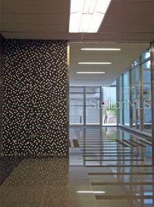 A modern hallway features a patterned accent wall, polished tile floors, and recessed ceiling lighting — 1500 F.D. ROOSEVELT AVE., GUAYNABO, PR