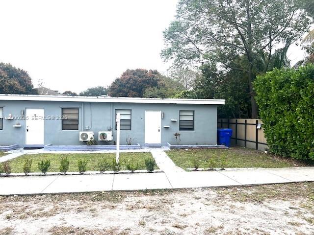 A single-story gray building features two white doors, windows, and exterior air conditioning units — 504 N 57th Ave, Hollywood FL 33021, HOLLYWOOD, FL