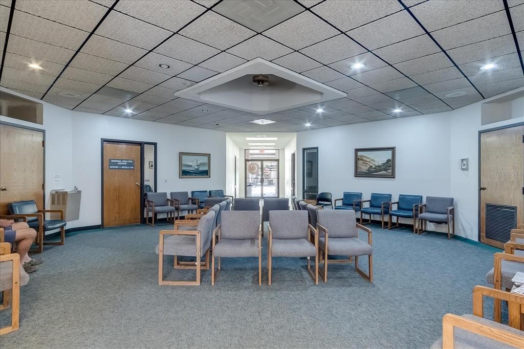 A waiting room features gray chairs, a drop ceiling with recessed lighting, and wood doors — 6801 US 27 HIGHWAY N UNIT C1+2, SEBRING, FL