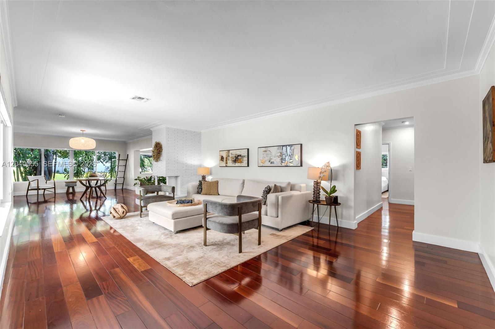 A single-story house with a brick driveway and lush landscaping under a blue sky — 8 Pinta Rd, Miami FL 33133, MIAMI, FL
