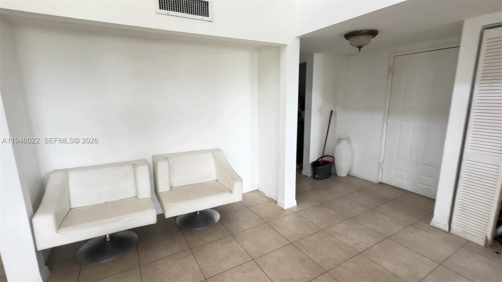A room features two white swivel chairs on a tiled floor near a doorway — 16220 NW 2nd Ave # 513, Miami FL 33169, MIAMI, FL