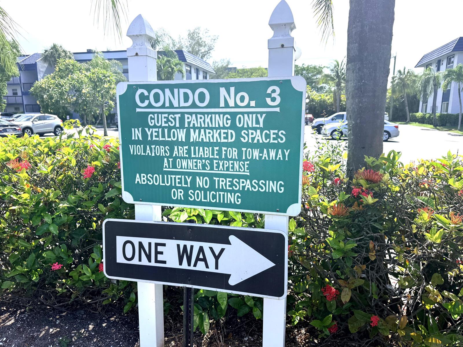 A green parking sign and a black one-way sign stand in front of a building — 3050 Holiday Springs Boulevard # 111, Margate FL 33063, MARGATE, FL