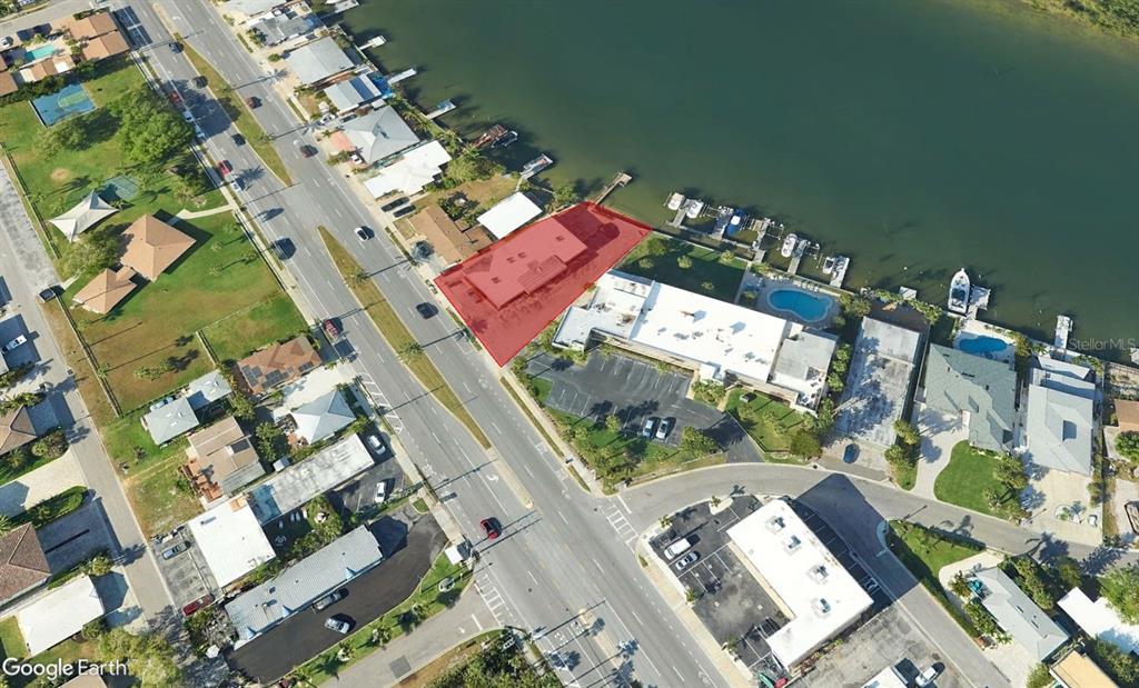 This aerial view shows a waterfront property highlighted in red along a coastal road — 18205 GULF BOULEVARD, REDINGTON SHORES, FL