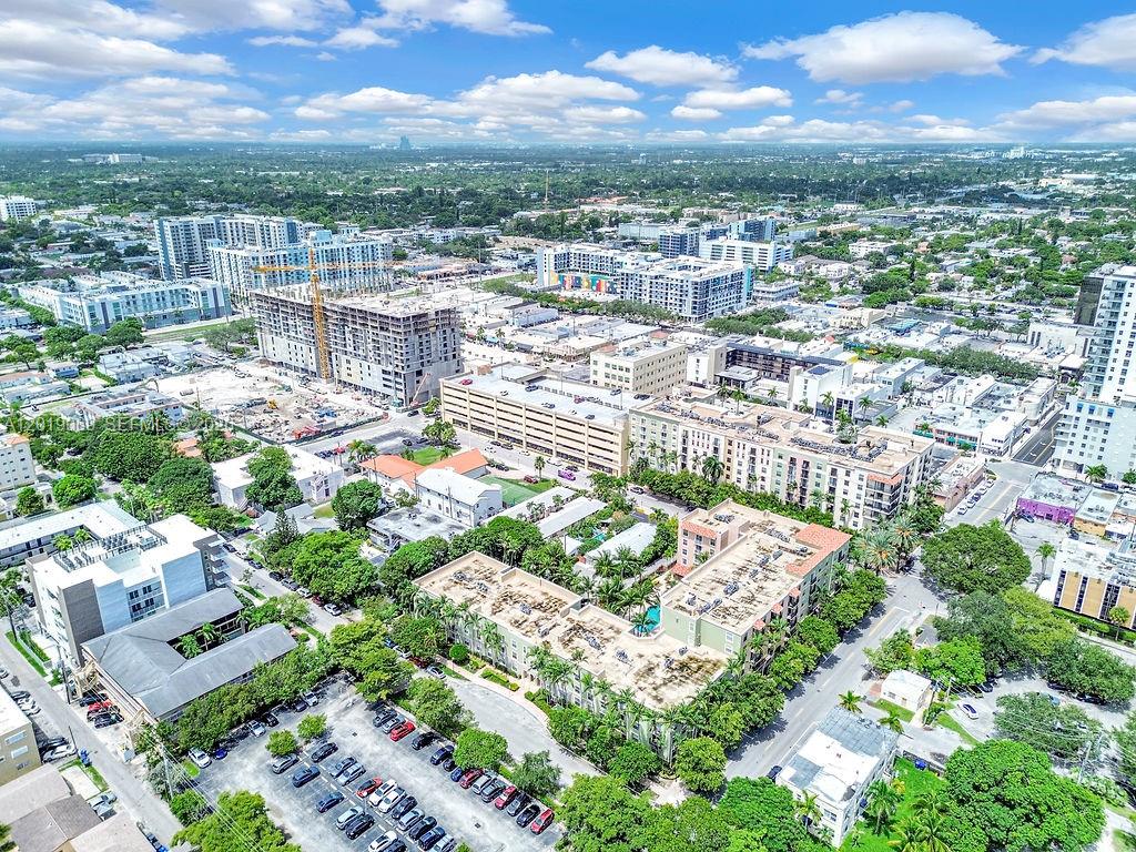 An aerial view shows a dense urban neighborhood with apartment buildings, construction sites, and parking lots — 1900 Van Buren St # 113B, Hollywood FL 33020, HOLLYWOOD, FL