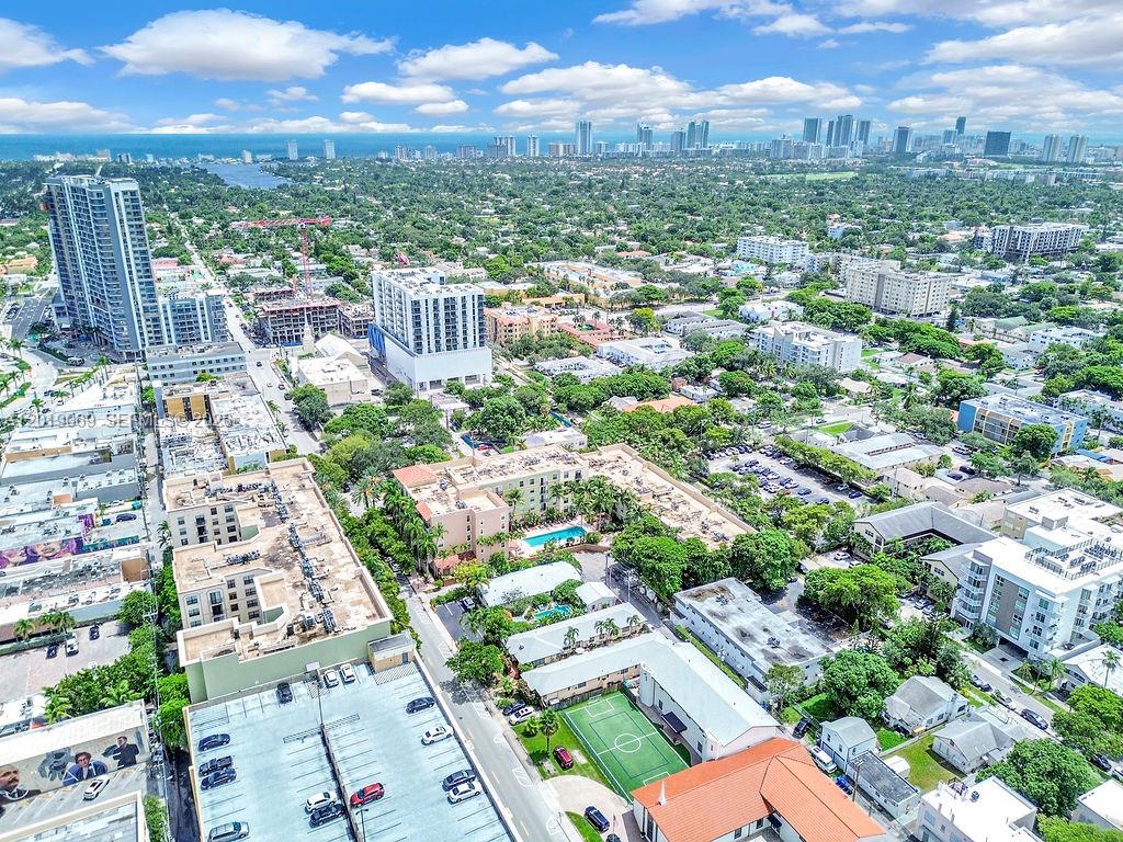 An aerial view shows a dense urban area with residential buildings, parking lots, and distant skyscrapers — 1900 Van Buren St # 113B, Hollywood FL 33020, HOLLYWOOD, FL