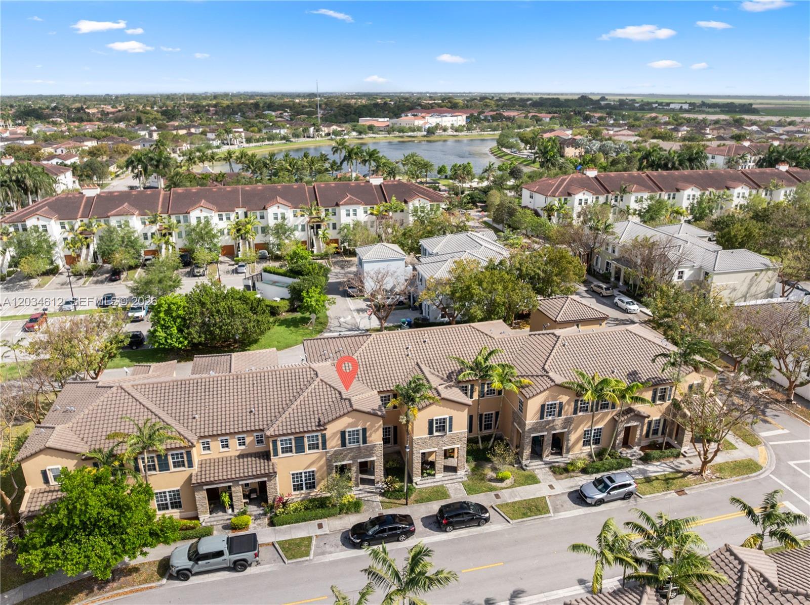 An aerial view shows a multi-unit residential building with a tiled roof and street parking — 16958 SW 92nd St # 16958, Miami FL 33196, MIAMI, FL
