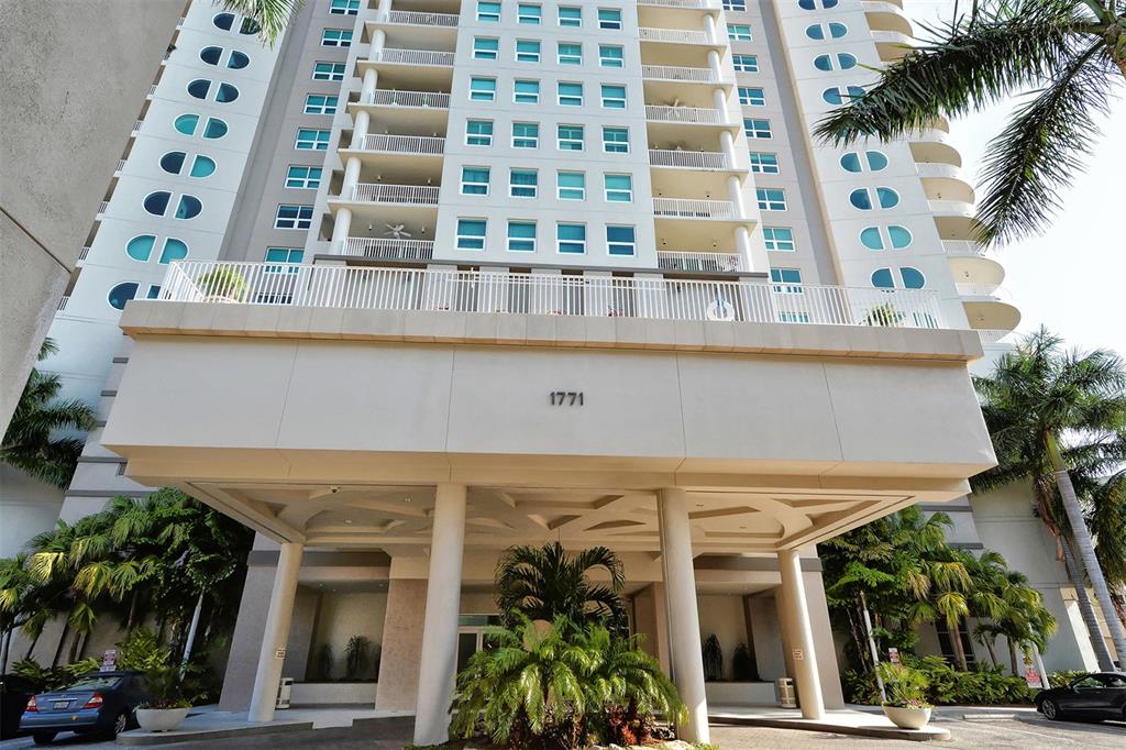 The exterior of a high-rise residential building features a large covered entrance with columns — 1771 RINGLING BOULEVARD UNIT 603, SARASOTA, FL