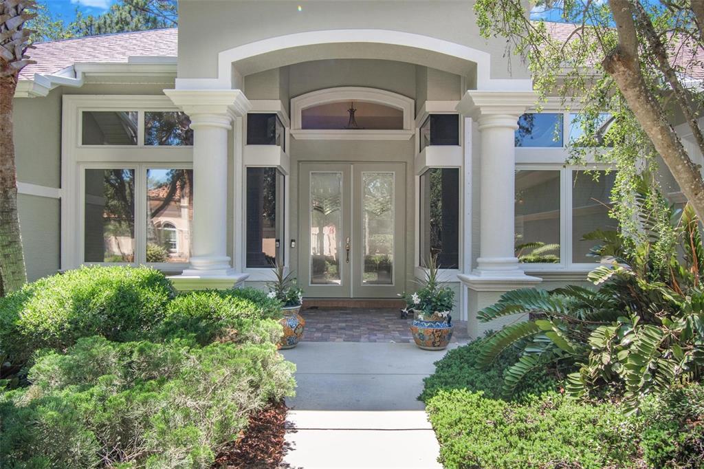 The exterior of a house features a double front door under a columned arched entryway — 10 S WATERVIEW DRIVE, PALM COAST, FL