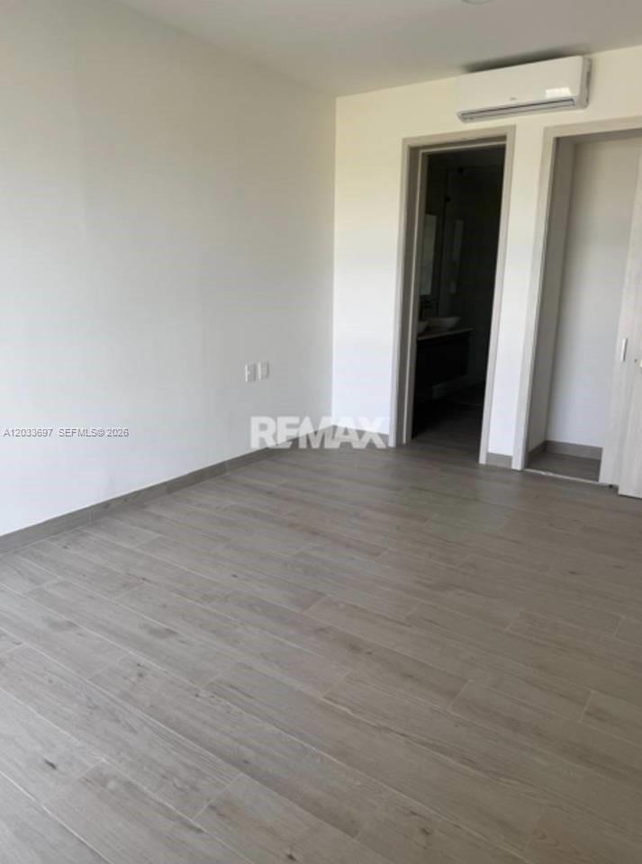 An empty room features light-colored wood-look tile flooring and a doorway leading to a bathroom — 605 Vermon # 605, FL, FL