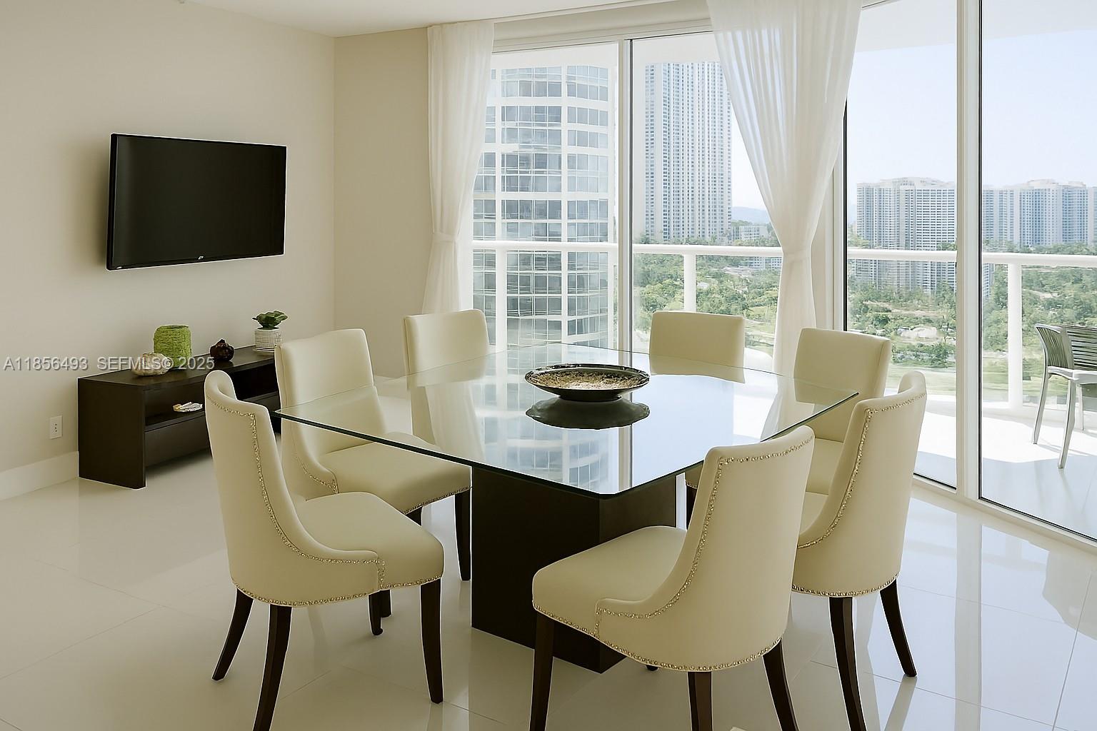 A dining room features a glass-topped table, six cream chairs, and a wall-mounted television — 250 Sunny Isles Blvd # 1506, Sunny Isles Beach FL 33160, SUNNY ISLES BEACH, FL