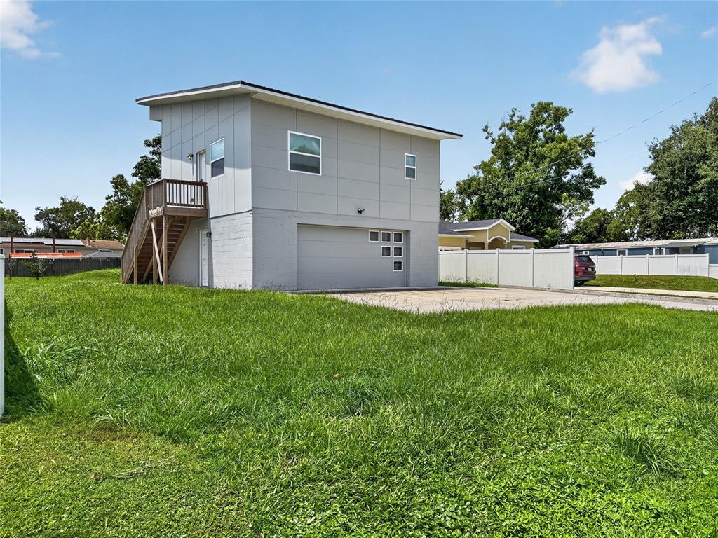 A two-story house with a gray exterior, a garage, and an outdoor staircase — 126 1ST STREET, ORLANDO, FL