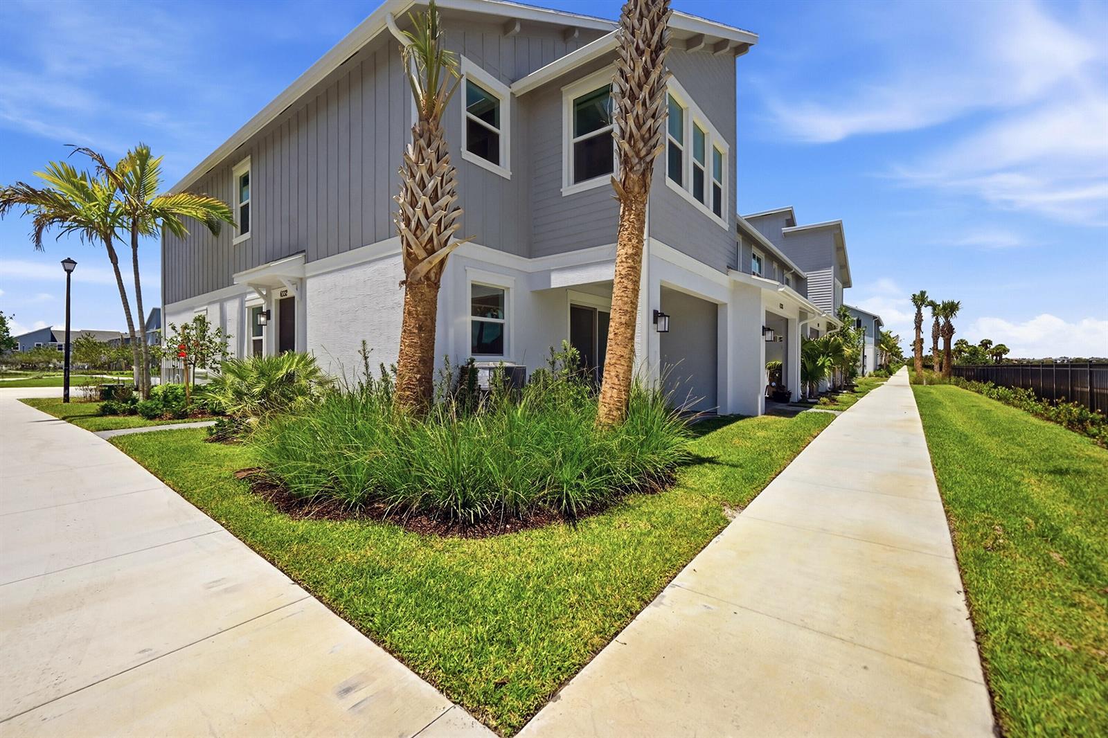 A two-story gray and white townhouse with palm trees and a sidewalk in the foreground — 4332 Brookgreen Square, Westlake FL 33470, WESTLAKE, FL