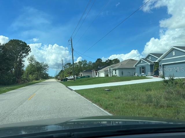 A street view shows a row of suburban houses with driveways along a paved road — 13100 ELEANOR AVENUE, PORT CHARLOTTE, FL